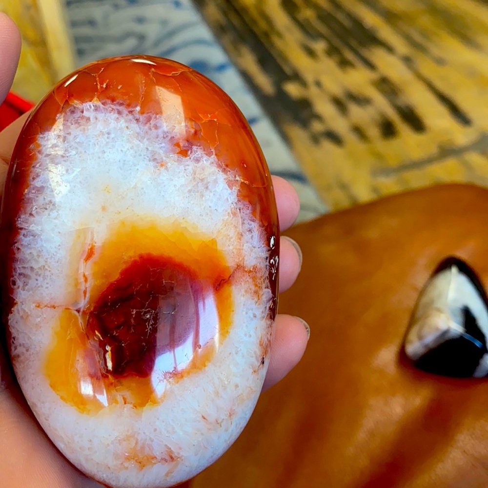 Red evil eye palm stone